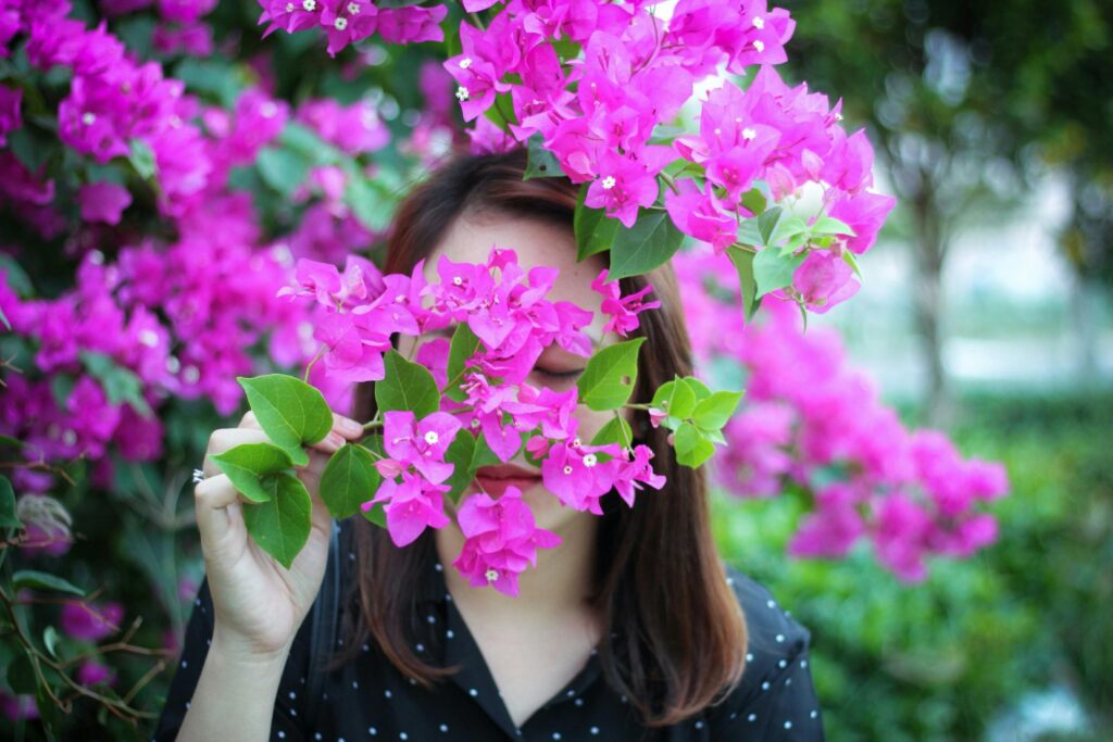 Photo of Woman Smelling Purple Flowers